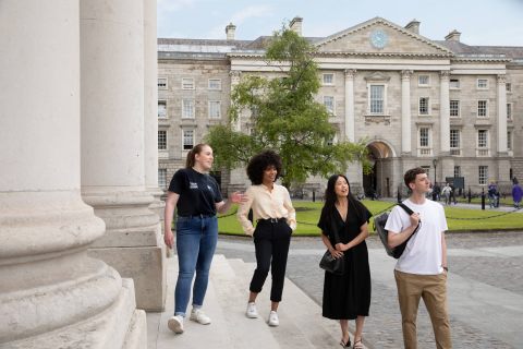tour group on steps of building in trinity college