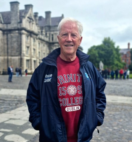 paul wearing a red trinity sweater and navy jacket