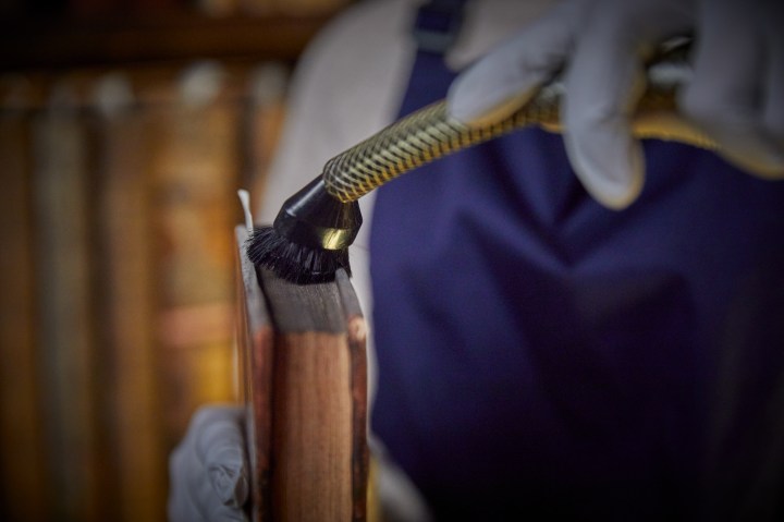 a brush cleaning the page rim of a book