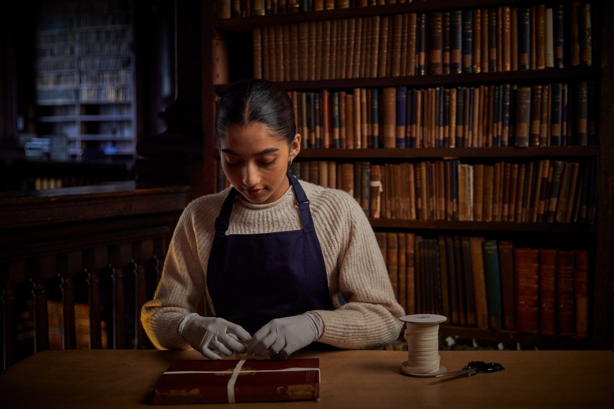 a woman wrapping a book in the old library
