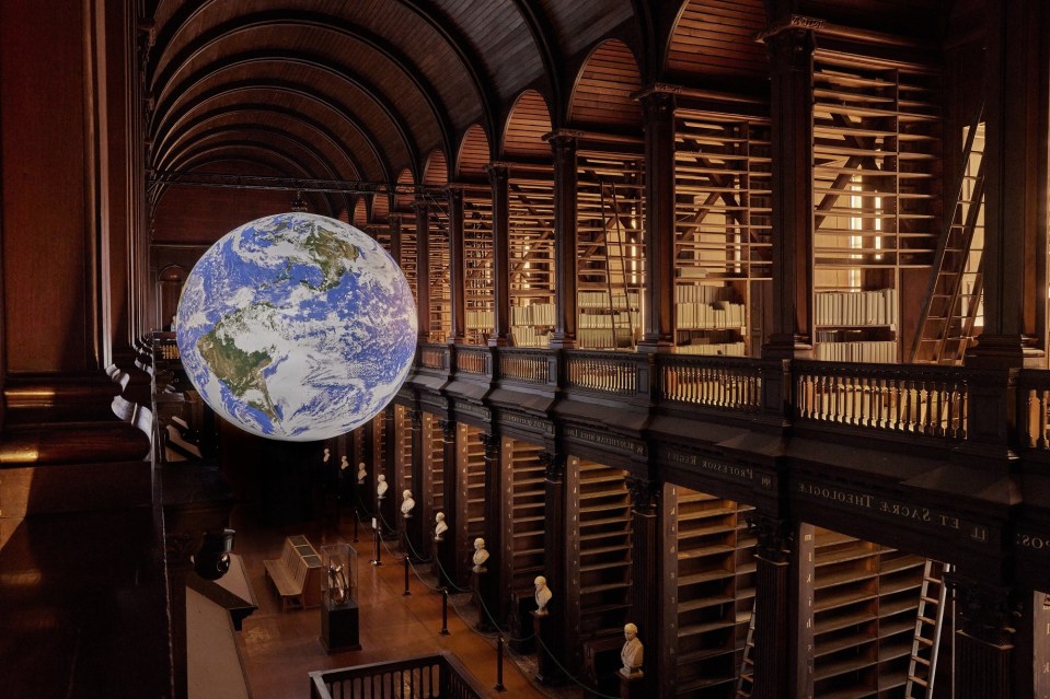 Image of Gaia in the Long Room from the upper floor, with empty book shelves