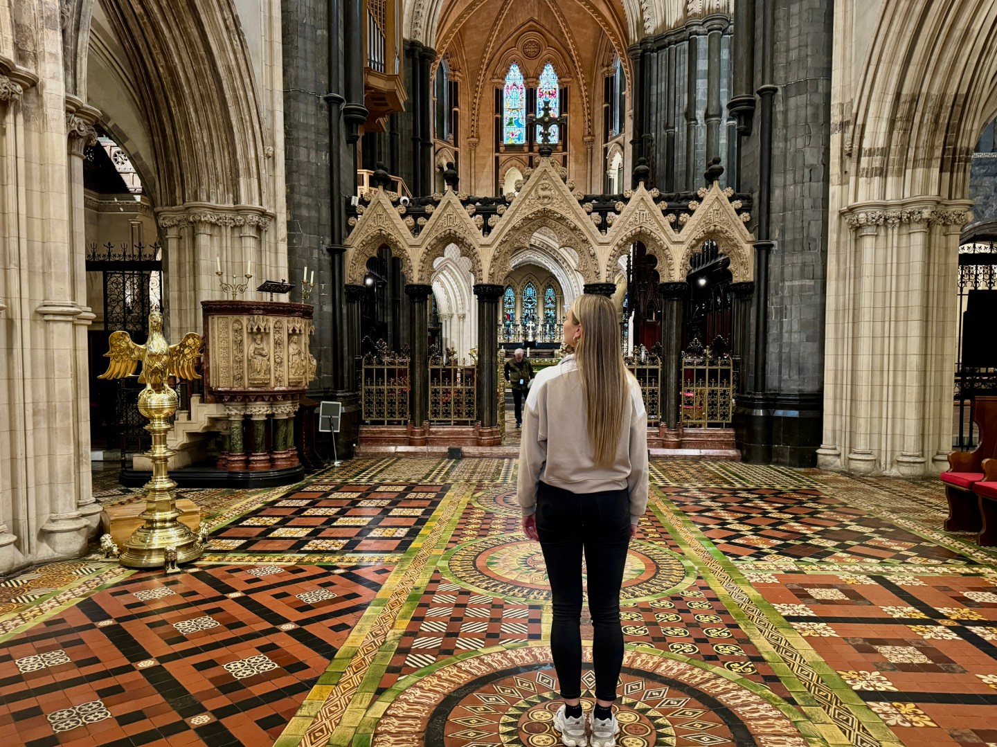 A woman standing in the middle of Christ Church, admiring the artwork