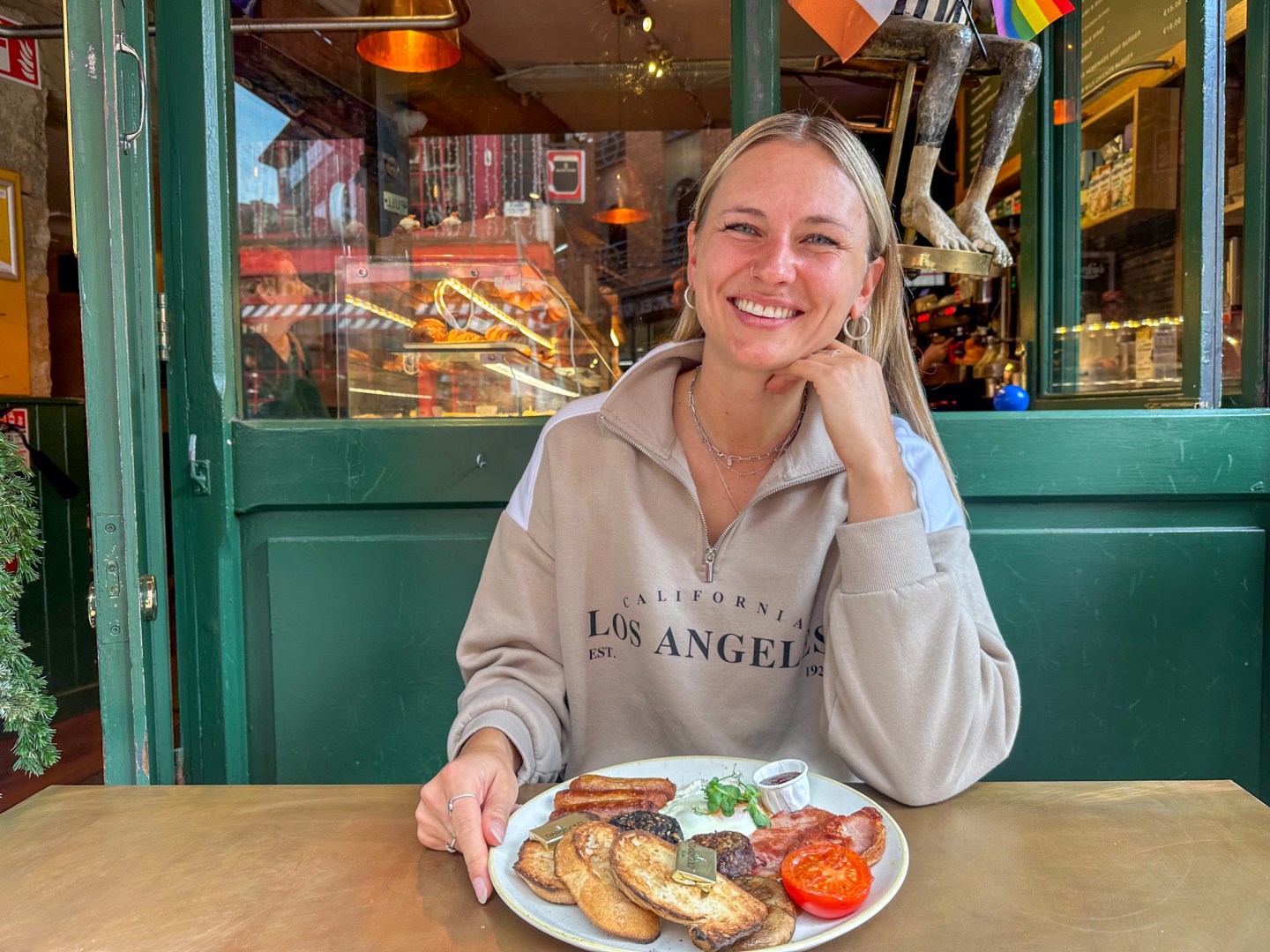 A woman sitting at Keoghs with her fry breakfast