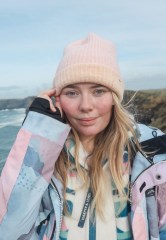 Image of Laura wearing a pink hat and blue, pink and purple coat