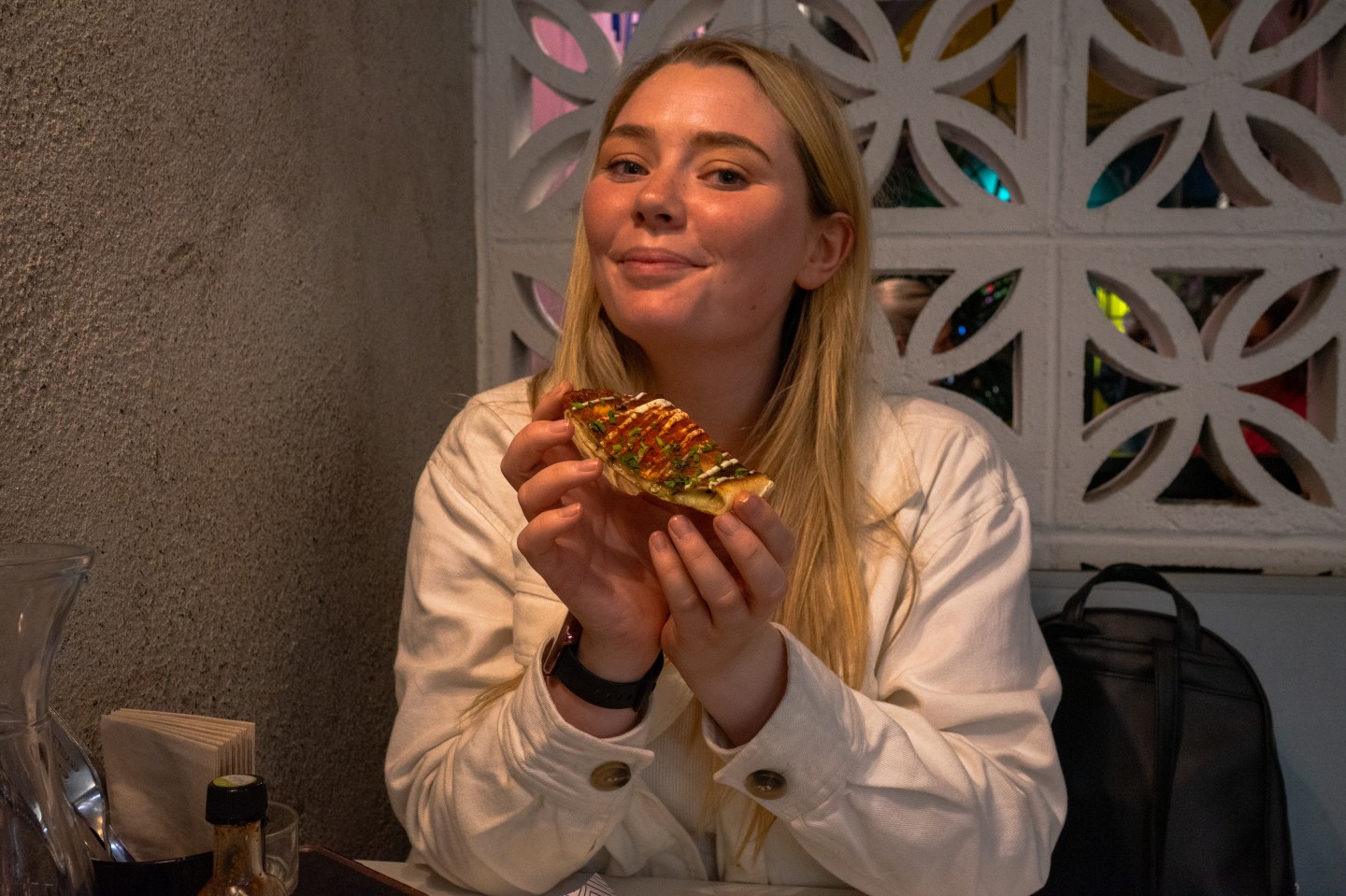 A woman enjoys her meal at Mexican restaurant Masa