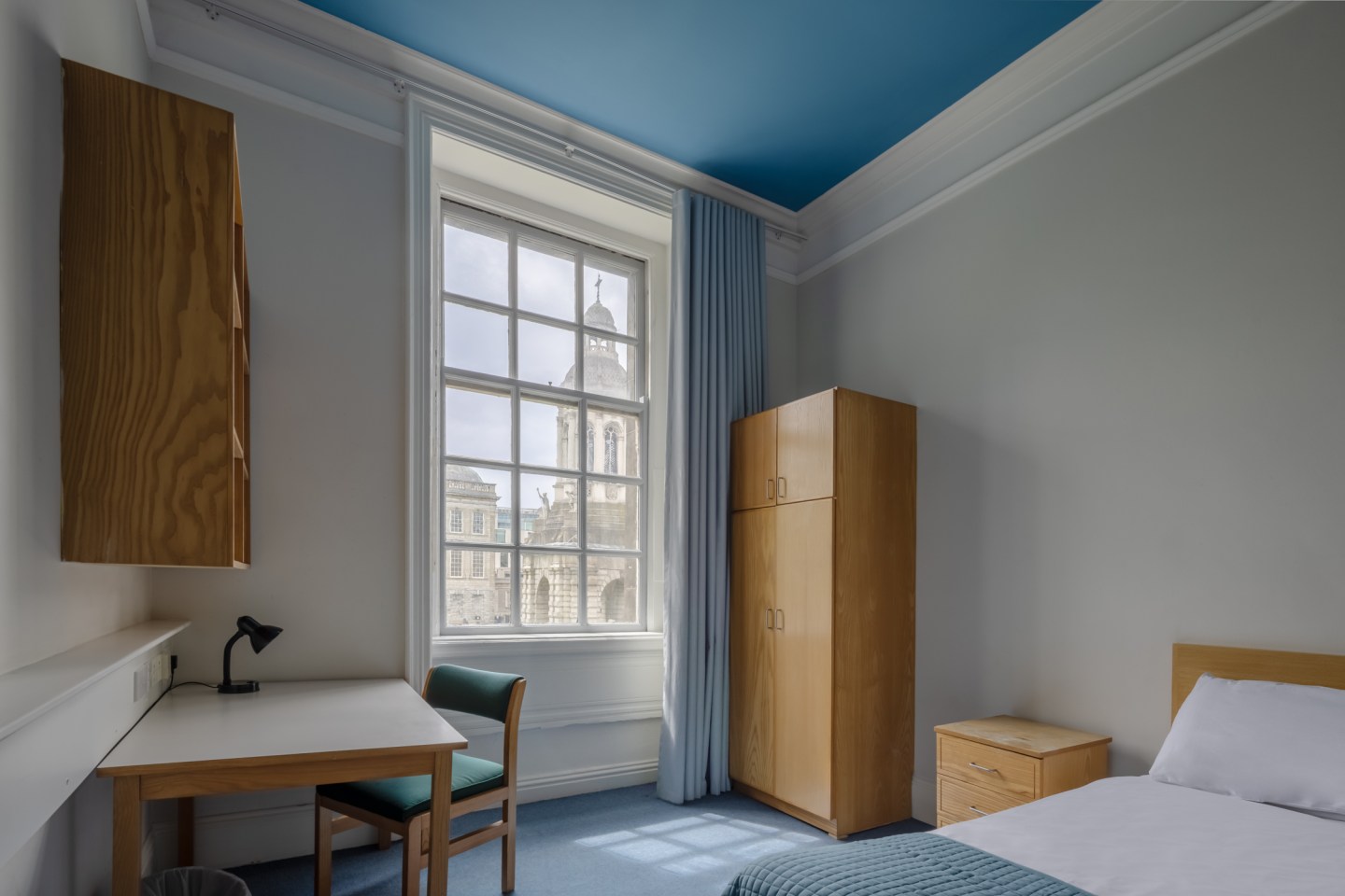 Image on Trinity College on-campus accommodation, with a window view of the bell tower on Front Square