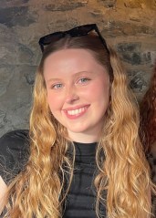 Photot of Clíodhna Brady wearing black sunglasses and a black dress