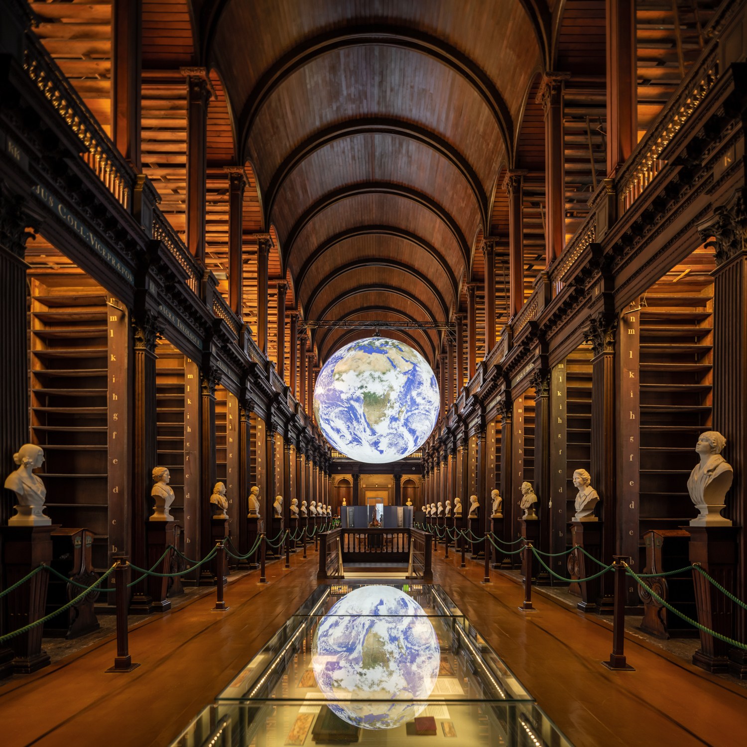 Gaia The artwork Gaia, a sculpture of an illuminated globe, suspended from the ceiling in the Long Room in the Old Library, during the historical walking tour of Trinity College.