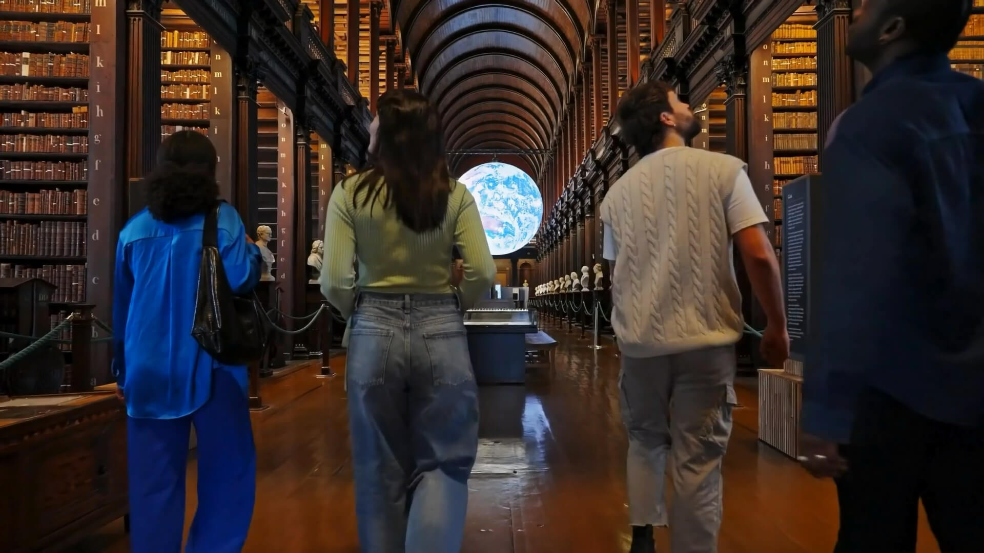 Image of three people walking into the Old Library at Trinity