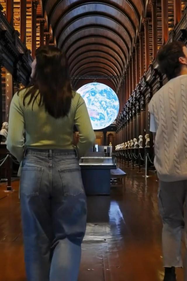 Image of two people walking into the Old Library at Trinity