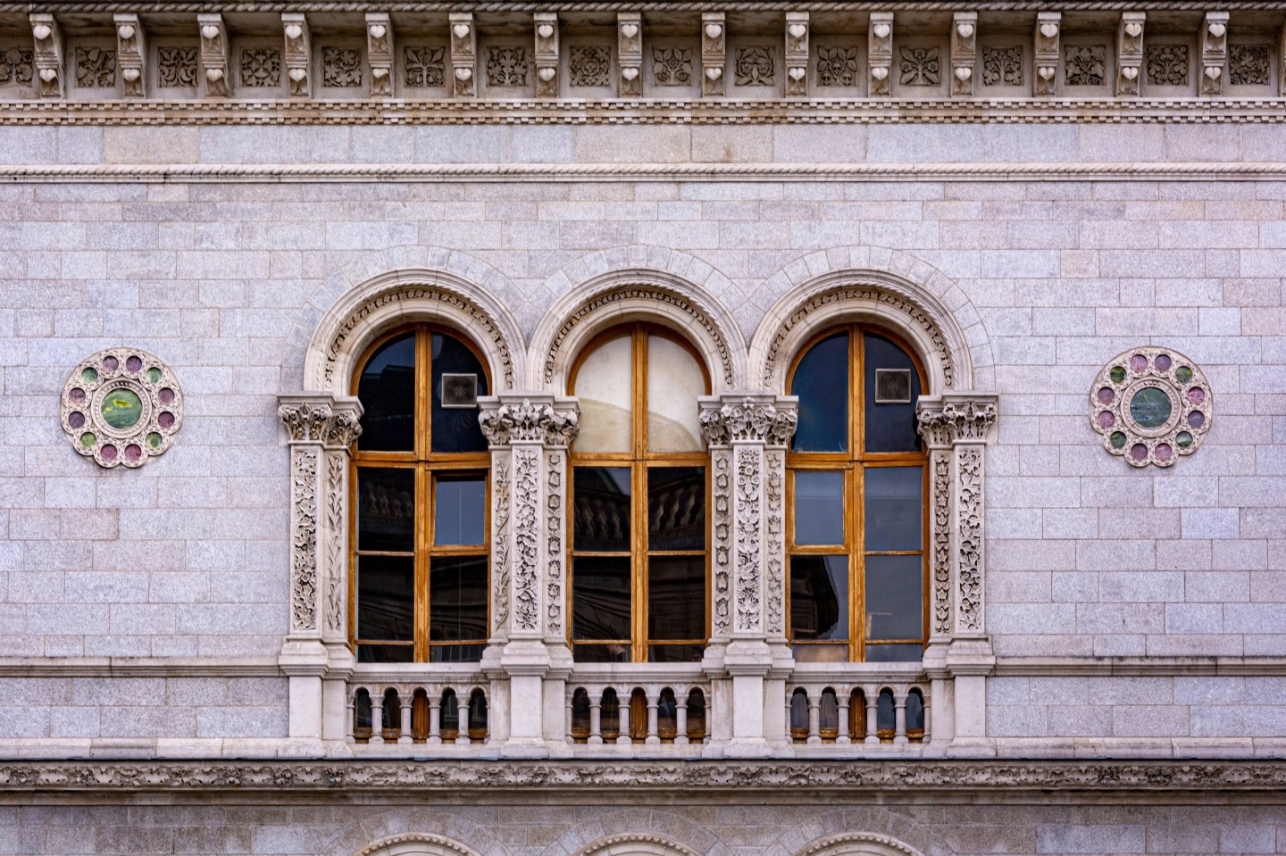 Image of three wooden windows, with beautiful carvings in the building at Trinity College, Dublin