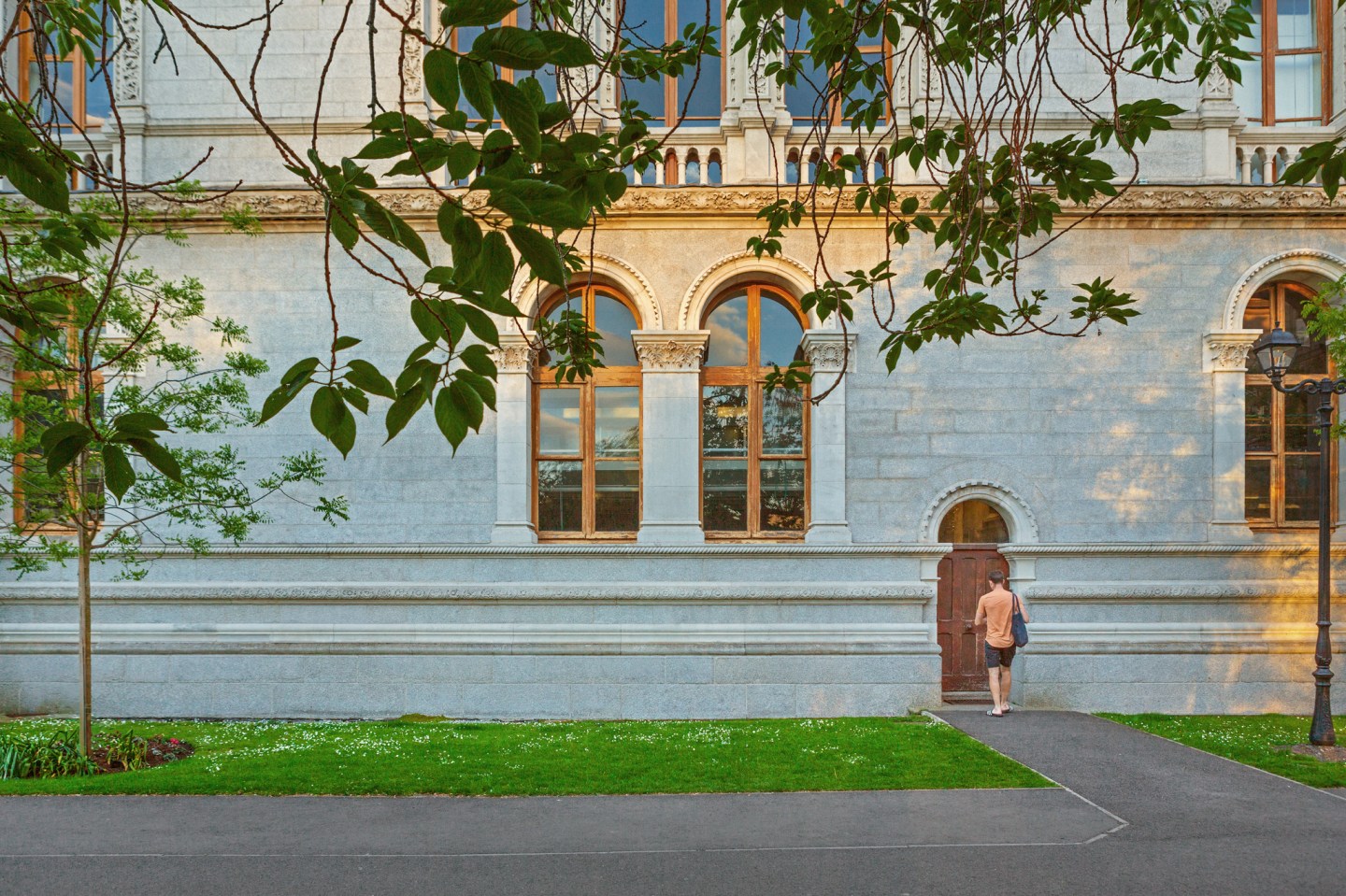 Image of a man walking into Trinity college