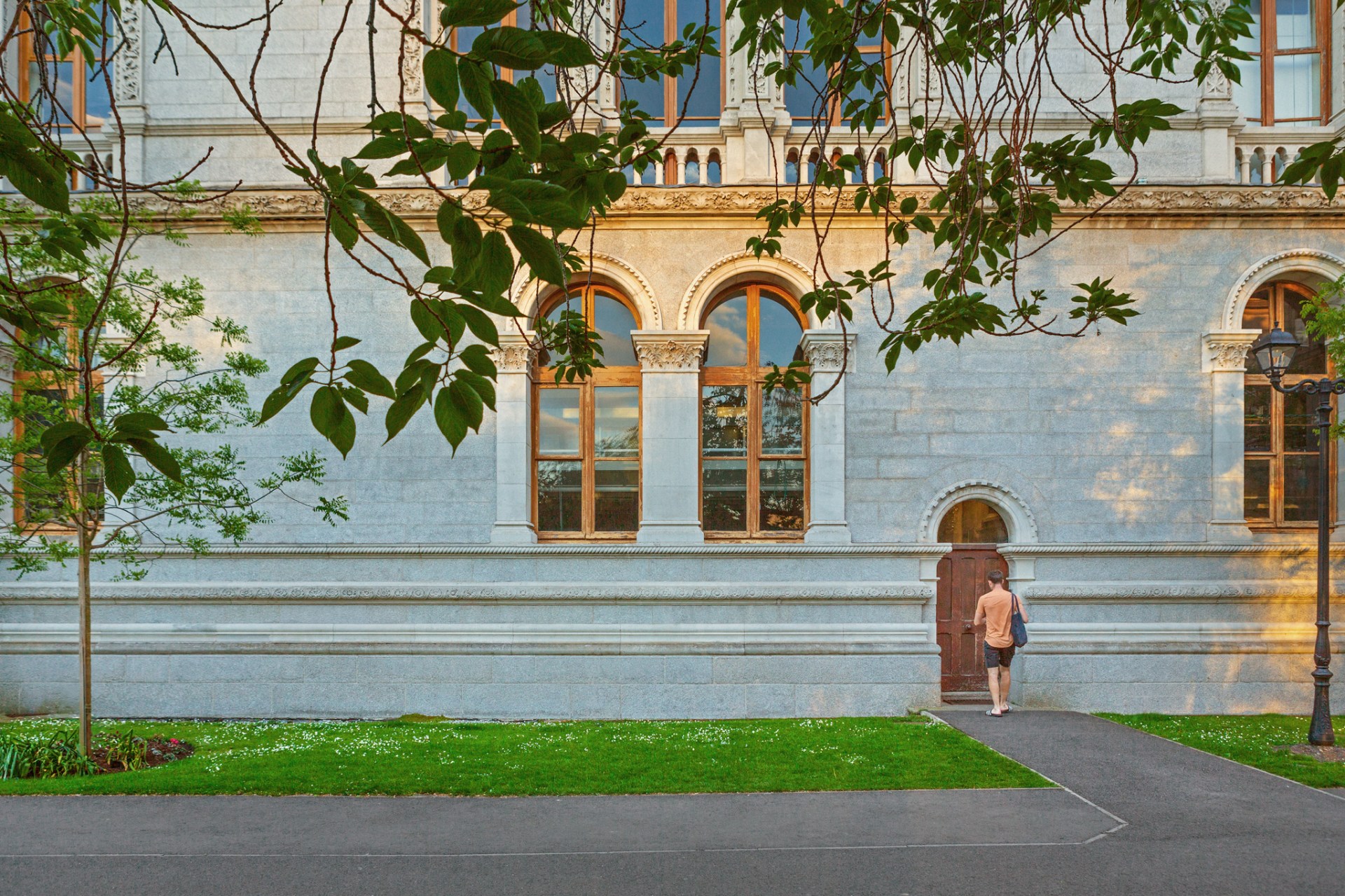 Image of a man walking into Trinity college