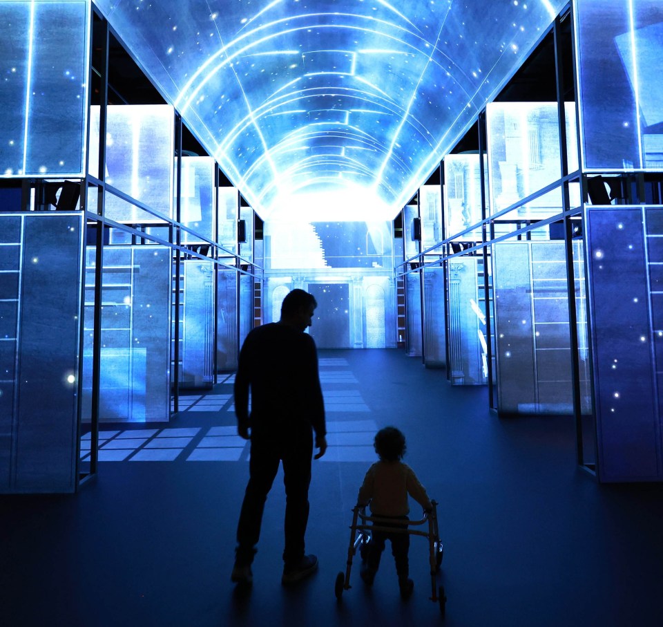 Image of a man and his son with a walker, admiring the view of The Book of Kells Experience