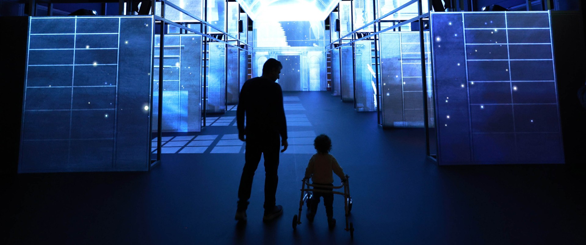 A man and his son with a walker, admiring the views of The Book of Kells Experience