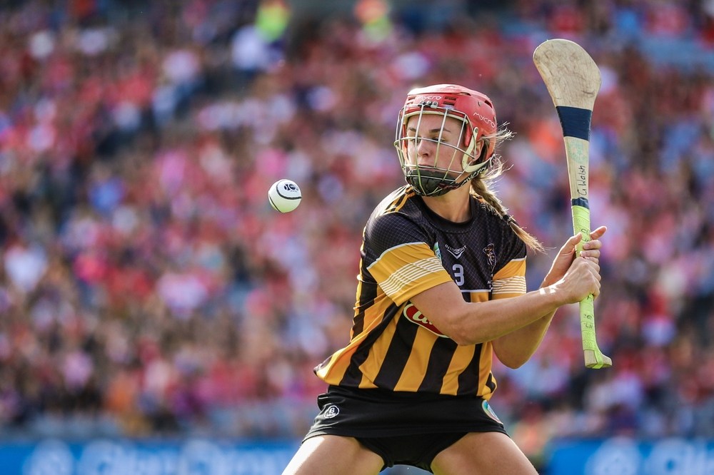 Image of a Kilkenny camogie player hitting a sliotar during the All-Ireland Camogie Final on the 7th August 2022