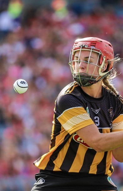 Image of a Kilkenny camogie player hitting a sliotar during the All-Ireland Camogie Final on 7th August 2022