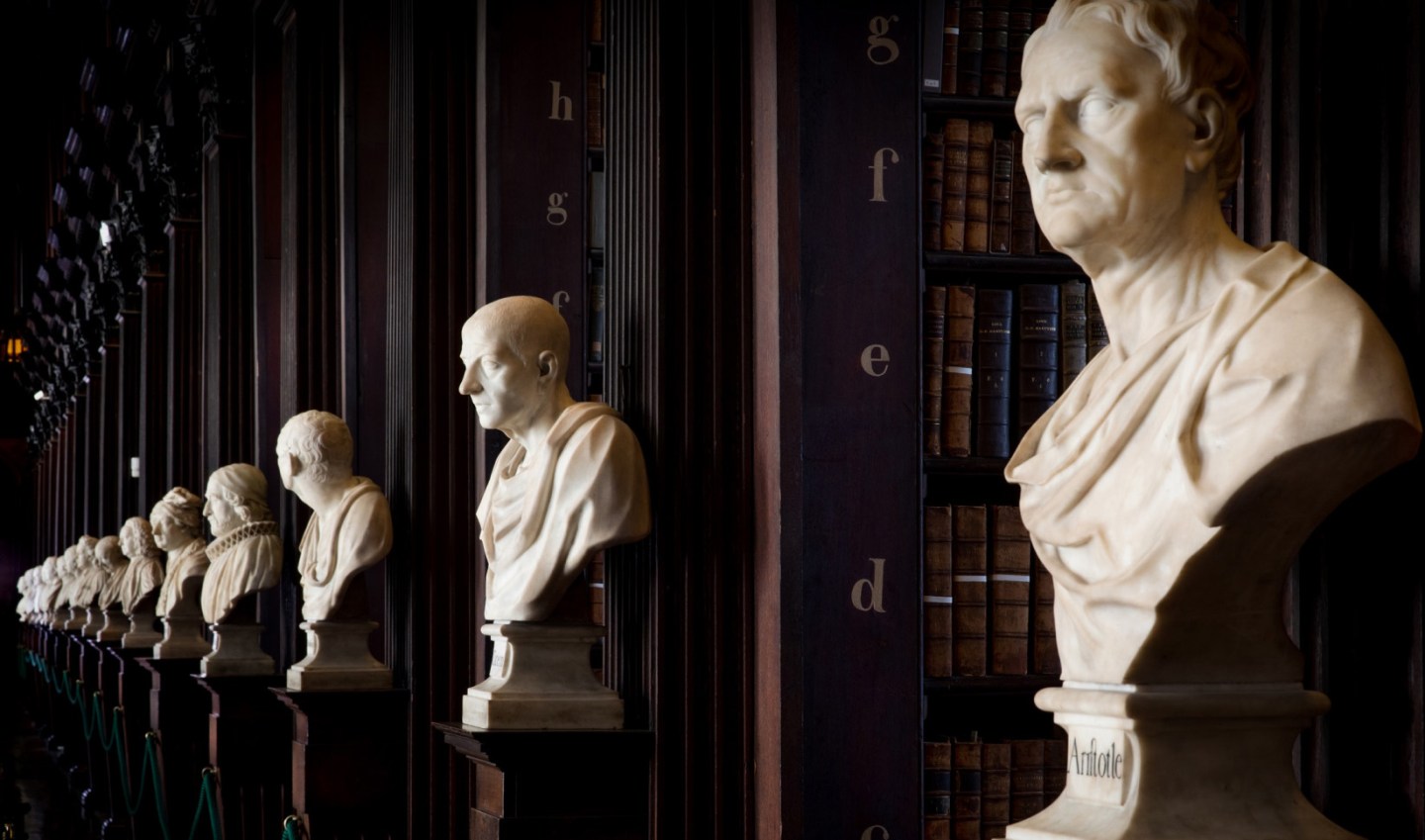 White statues along the aisles in the old library